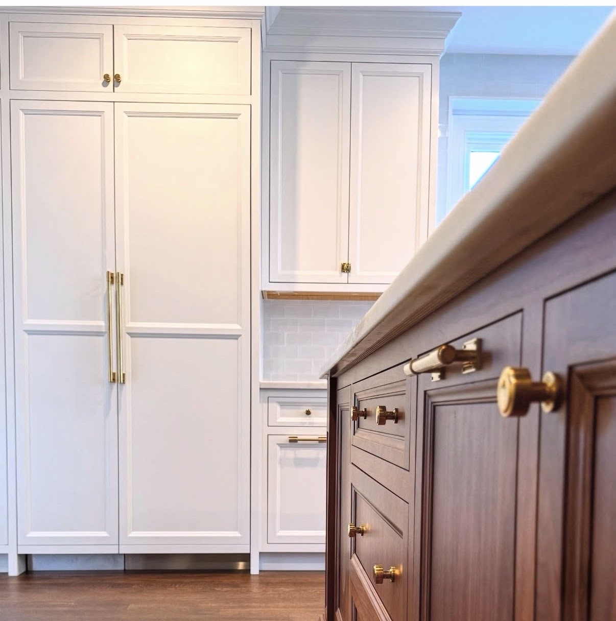 Custom cabinet installation with brass hardware