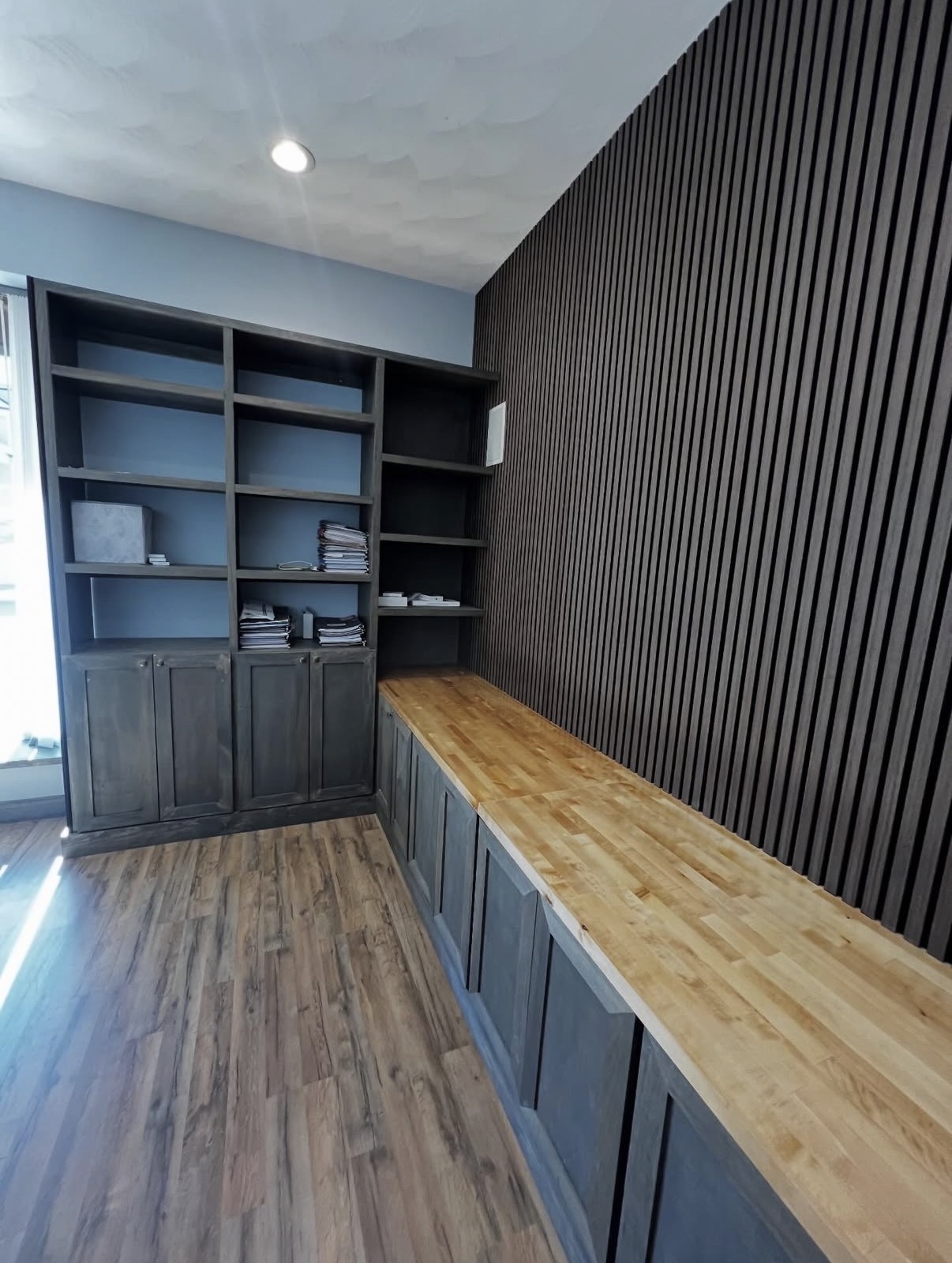Custom office with slat wall and butcher block counter
